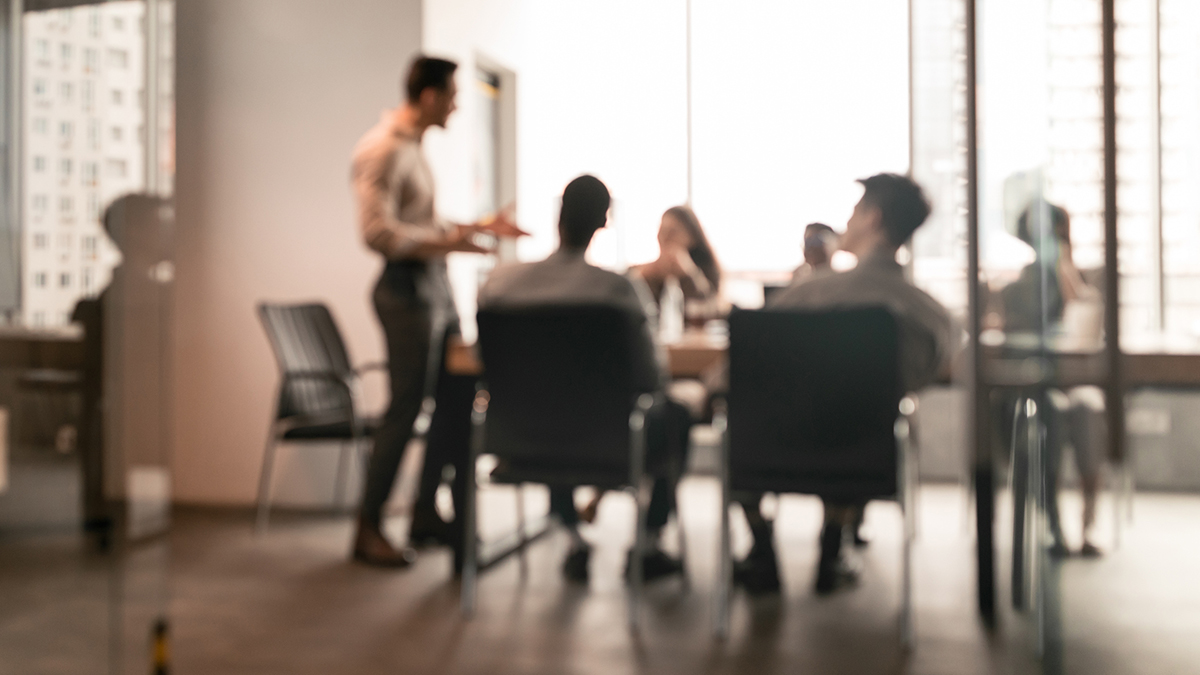 Group of managers discuss strategy in a conference room