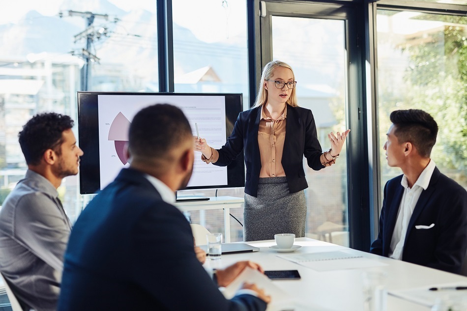 Young CEO delivering a presentation to her colleagues in a boardroom